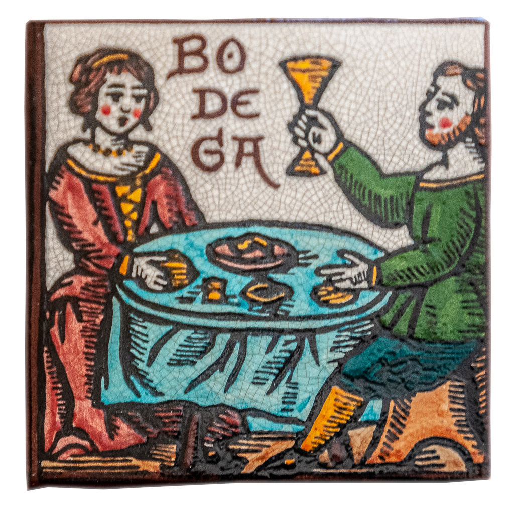 Baldosa de cerámica con una pareja comiendo de la fachada del Mesón el Sol de Olite